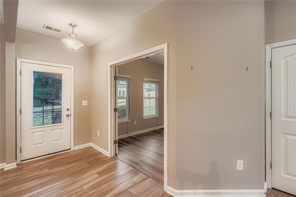 114 Greenbrier Way Canton, GA 30114 - Photo 6 of 32 a view of an empty room with wooden floor and a window
