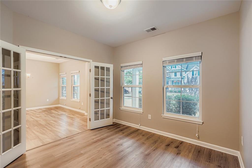 114 Greenbrier Way Canton, GA 30114 - Photo 7 of 32 an empty room with wooden floor and windows
