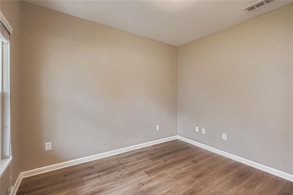 114 Greenbrier Way Canton, GA 30114 - Photo 8 of 32 a view of an empty room with wooden floor and a window