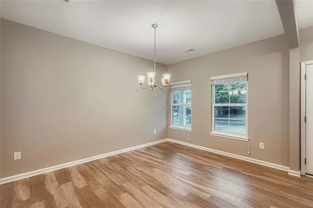 a view of livingroom with window hardwood floor and a ceiling fan