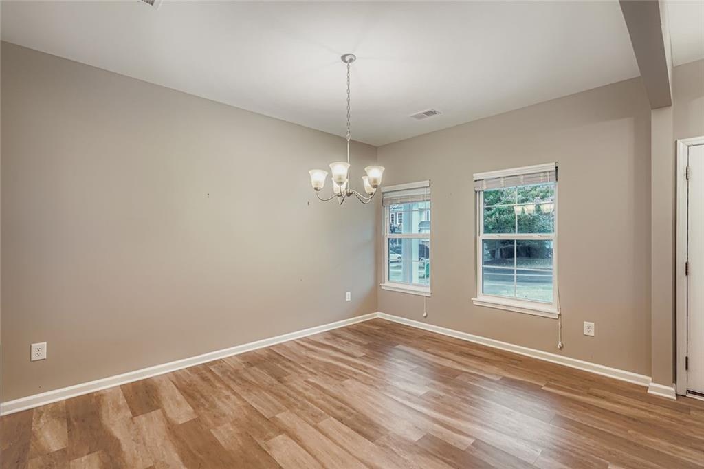 114 Greenbrier Way Canton, GA 30114 - Photo 9 of 32 a view of livingroom with window hardwood floor and a ceiling fan