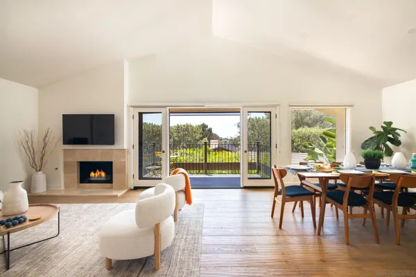 a living room with fireplace furniture and a large window