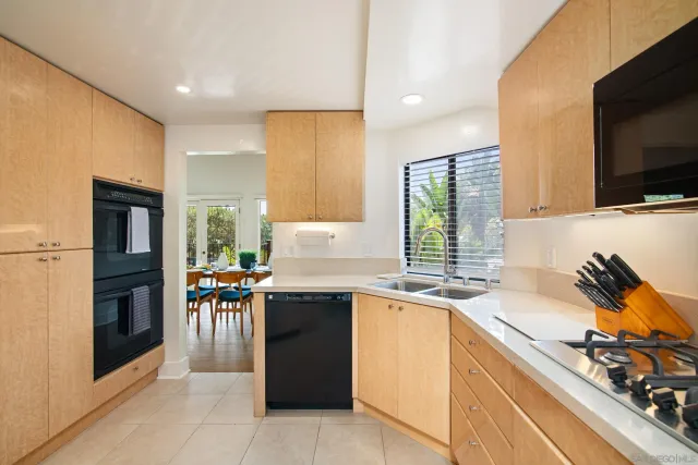 a kitchen that has a sink and a stove in it