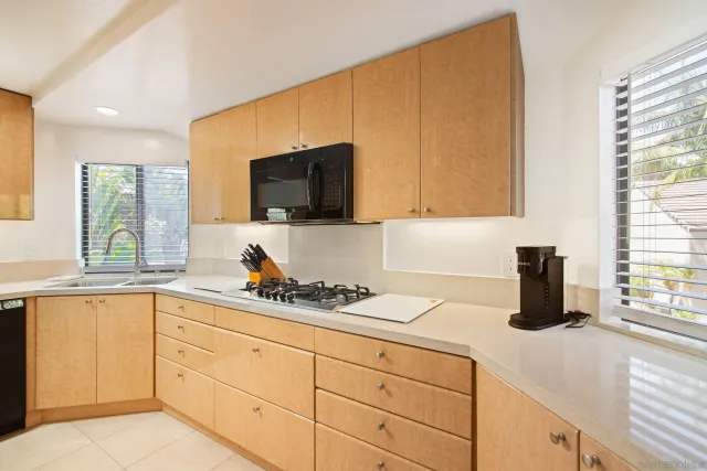 a kitchen with white cabinets and a sink