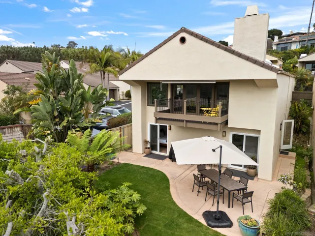 an aerial view of a house with table and chairs