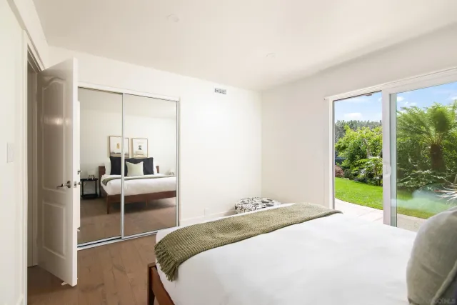 a bedroom with a bed and a large window