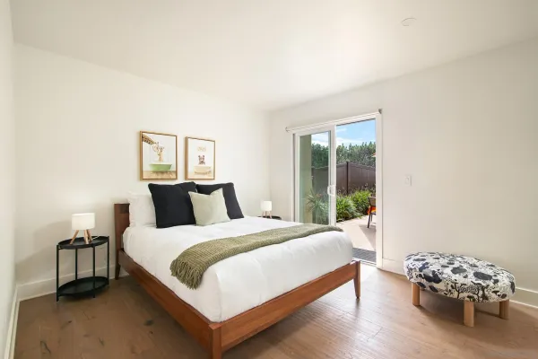 a bedroom with a bed and a window