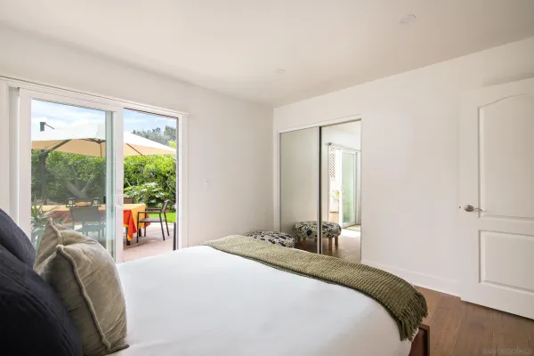 a bedroom with a bed and a large window