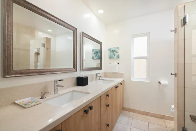 a bathroom with a double vanity sink mirror and