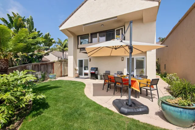 a view of a house with backyard sitting area and garden