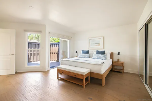 a spacious bedroom with a bed and a large window