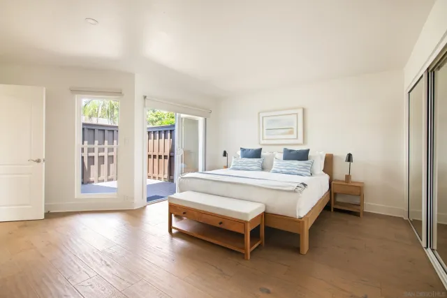 a spacious bedroom with a bed and a large window