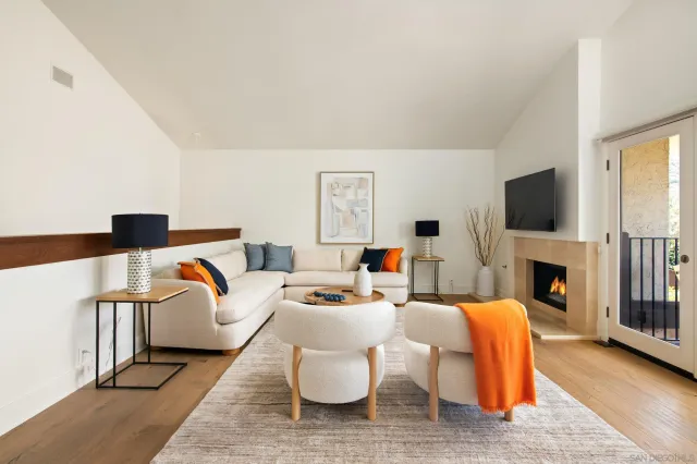 a living room with fireplace furniture and a flat screen tv