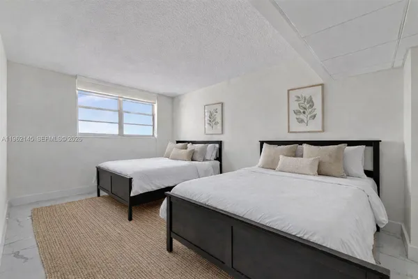 a bedroom with two beds and a window