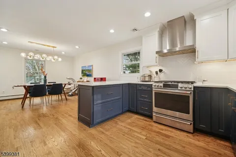 a bedroom with a bed a chair and a dresser in it