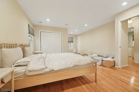a view of a workspace with furniture and wooden floor