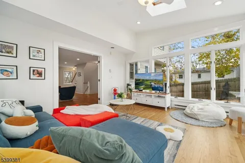 a view of a dining room with furniture and a chandelier