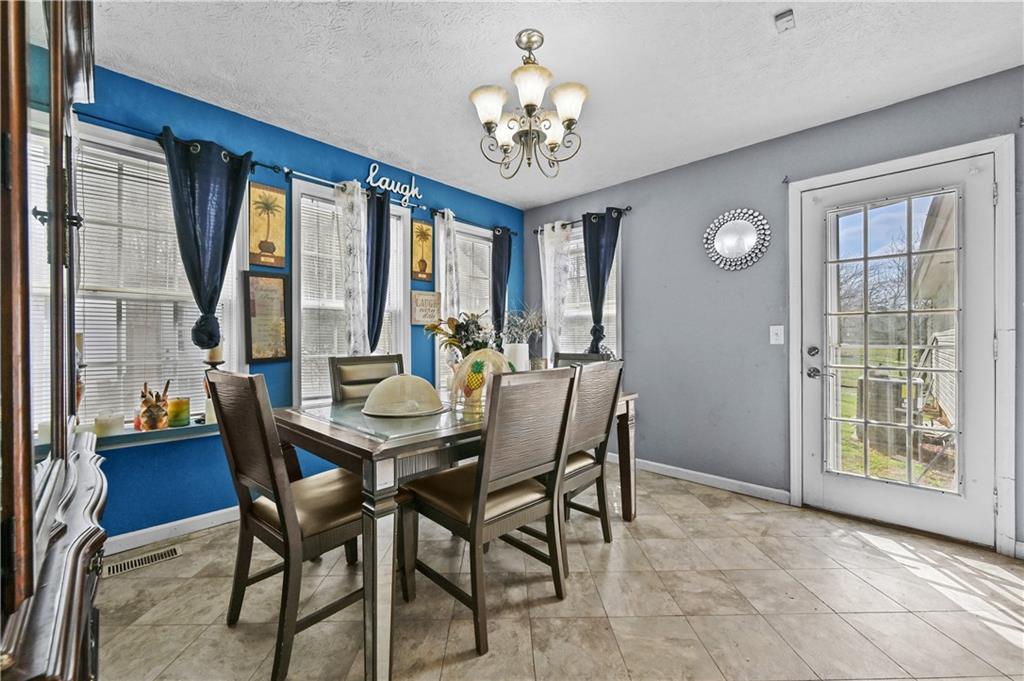 125 Tricias Way Temple, GA 30179 - Photo 12 of 39 a view of a dining room with furniture and a chandelier