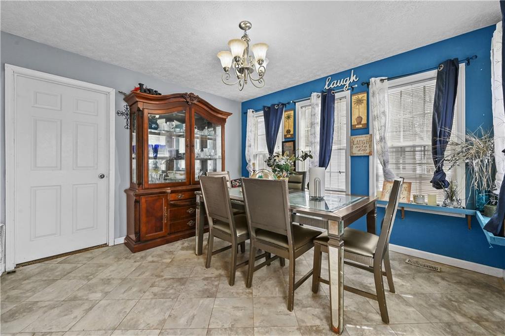 125 Tricias Way Temple, GA 30179 - Photo 14 of 39 a view of a dining room with furniture and a chandelier
