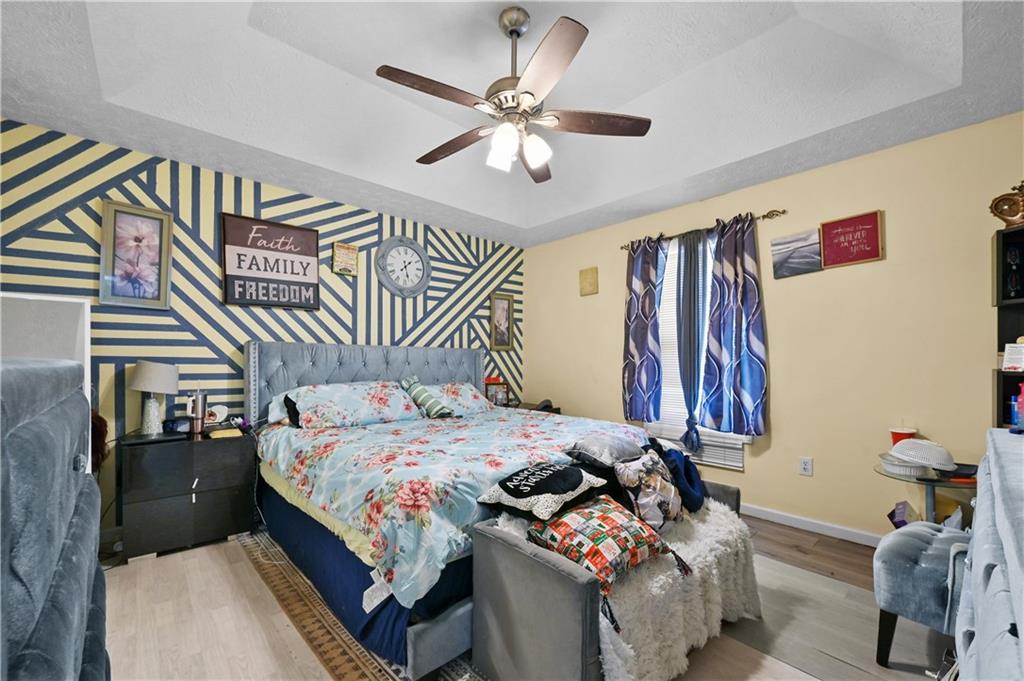 125 Tricias Way Temple, GA 30179 - Photo 16 of 39 a bedroom with a bed and a chandelier