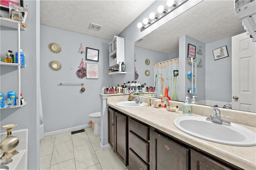 125 Tricias Way Temple, GA 30179 - Photo 19 of 39 a bathroom with a sink a toilet and a mirror