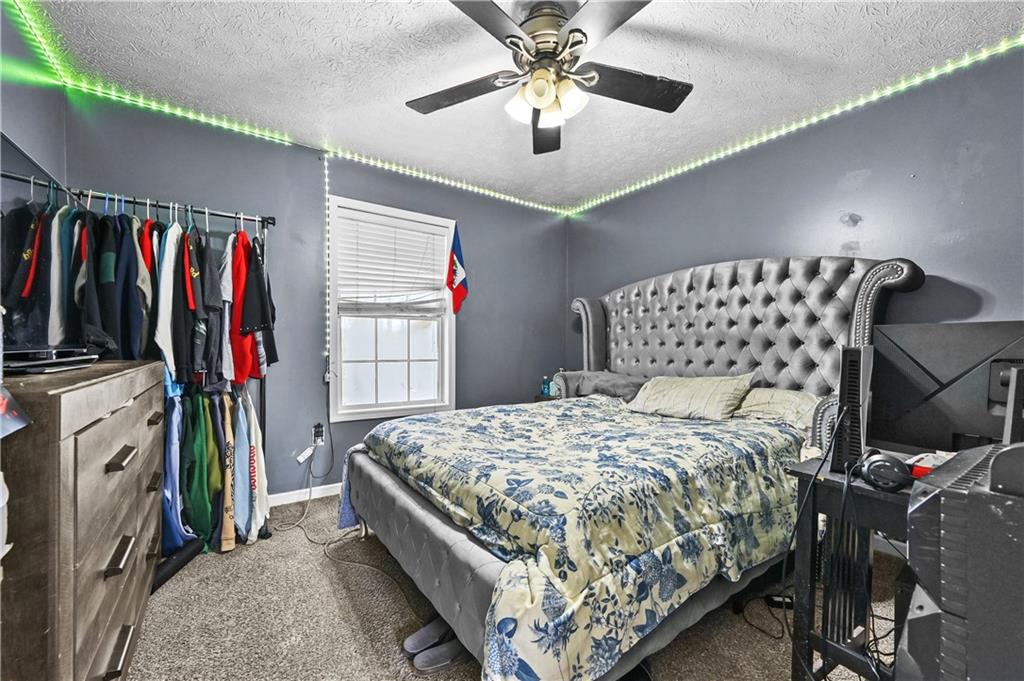 125 Tricias Way Temple, GA 30179 - Photo 22 of 39 a bedroom with a bed and a walk in closet