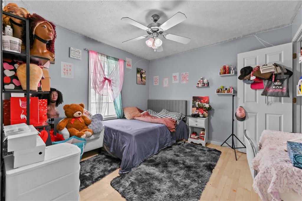 125 Tricias Way Temple, GA 30179 - Photo 23 of 39 a bedroom with bed and a chandelier