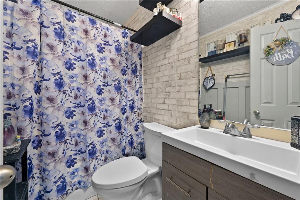 125 Tricias Way Temple, GA 30179 - Photo 24 of 39 a bathroom with a granite countertop toilet and a sink