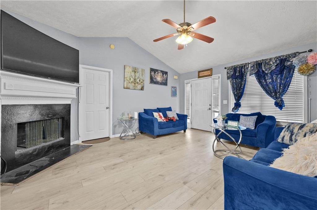 125 Tricias Way Temple, GA 30179 - Photo 8 of 39 a living room with furniture a fireplace and a table