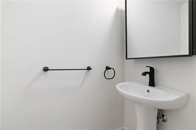 a bathroom with a sink and mirror