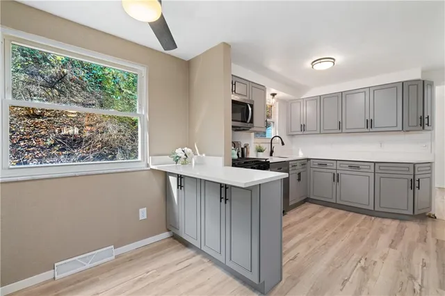 a kitchen with a sink cabinets and window