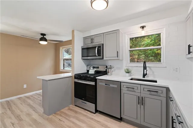 a kitchen with a sink cabinets and window