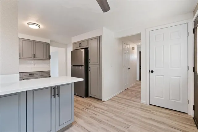a kitchen with kitchen island stainless steel appliances a refrigerator and cabinets