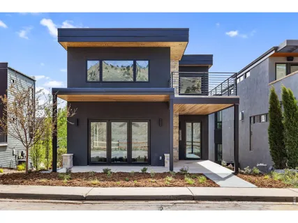a kitchen with stainless steel appliances granite countertop a sink a stove a refrigerator and island with wooden floor