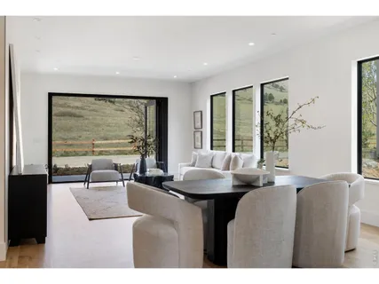 a open kitchen with white cabinets and wooden floor