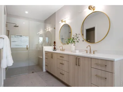 a living room with stainless steel appliances kitchen island granite countertop a refrigerator a sink a stove and white cabinets with wooden floor