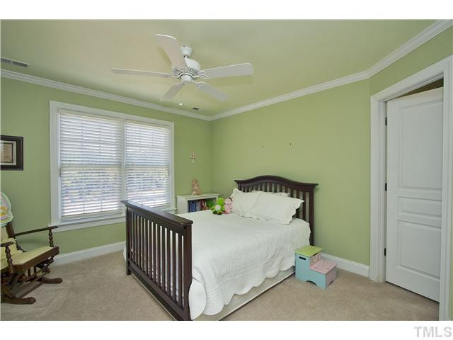 8717 Oregon Inlet Court Raleigh, NC 27603 - Photo 20 of 25 Another bedroom with crown moulding and walk-in closet. Lots of closets in this home! Bedroom