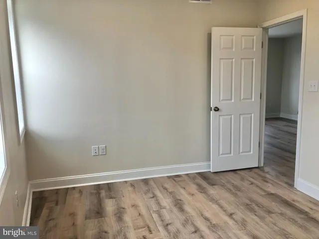 an empty room with wooden floor