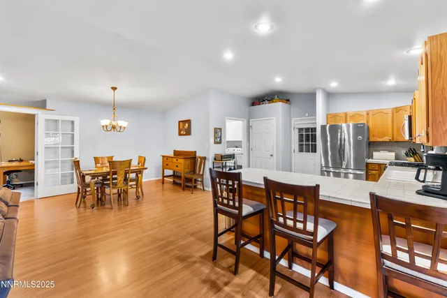 a large kitchen with a table and chairs