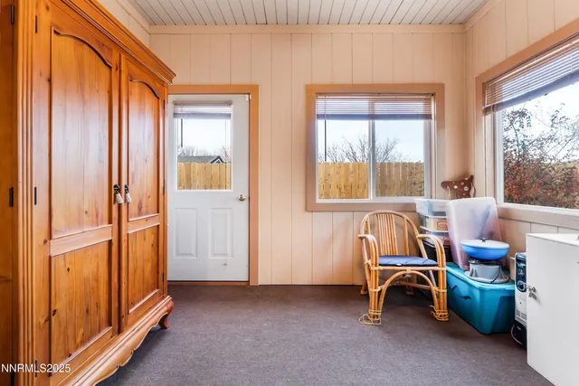 a view of a room with lounge chair and windows