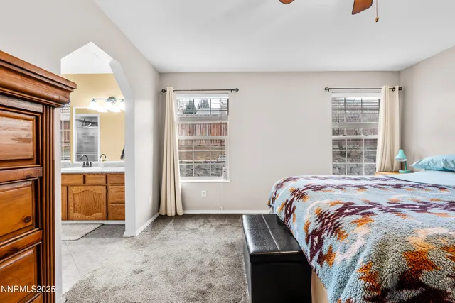 a bed sitting in a room next to a window