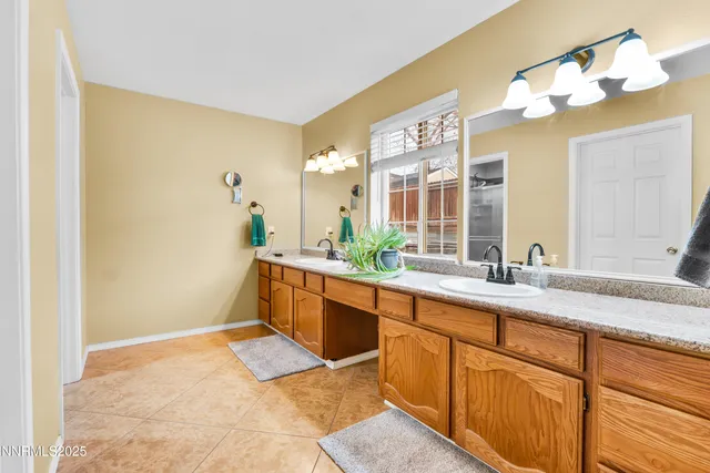 a spacious bathroom with a granite countertop sink a mirror and a