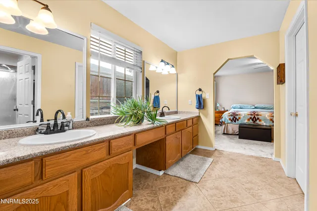a large bathroom with double vanity and a mirror