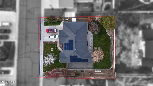 a view of a backyard with table and chairs and a large tree