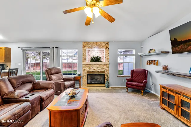 a living room with furniture fireplace and window