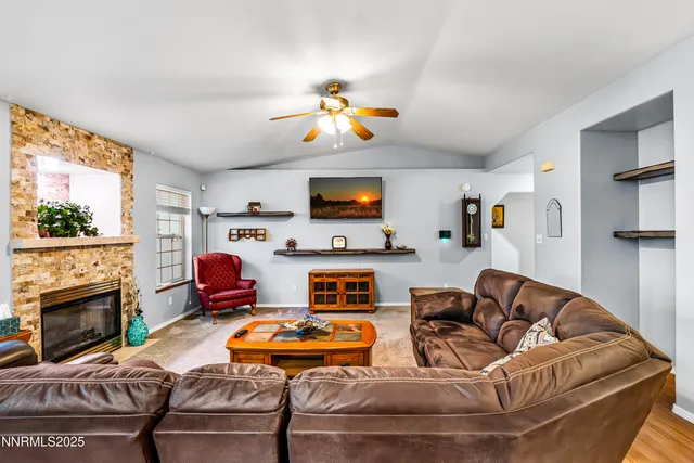 a living room with furniture fireplace and flat screen tv