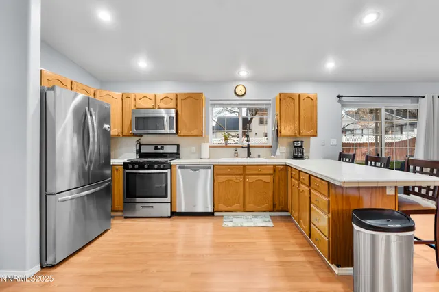 a kitchen with stainless steel appliances granite countertop a refrigerator stove and sink