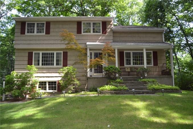 86 Seth Low Mountain Road Ridgefield, CT 06877 - Photo 1 of 1 a front view of a house with a yard and porch