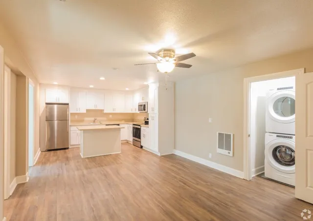 a view of a kitchen with a sink dishwasher and a fireplace