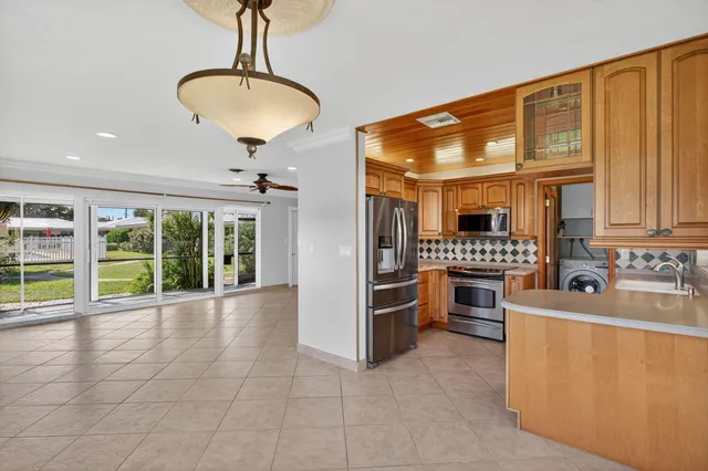 a view of kitchen with sink and refrigerator